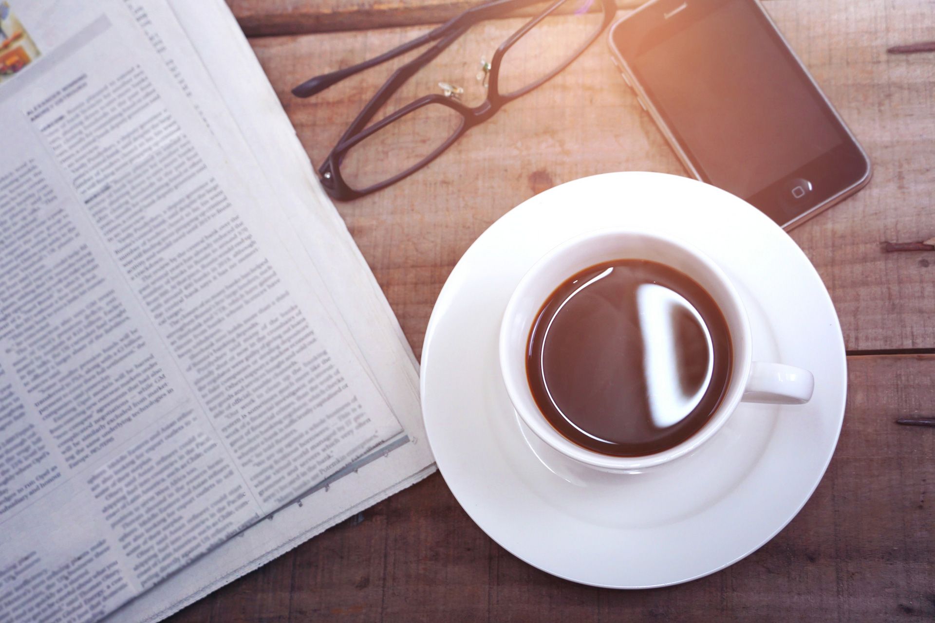 A cup of coffee and a newspaper