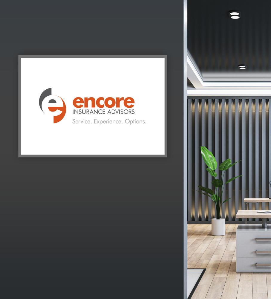 Encore Insurance Advisors logo on a framed sign, mounted on a dark gray wall, interior office view.