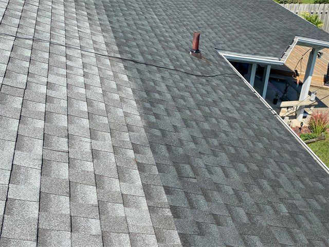 A black roof with a yellow hose attached to it.