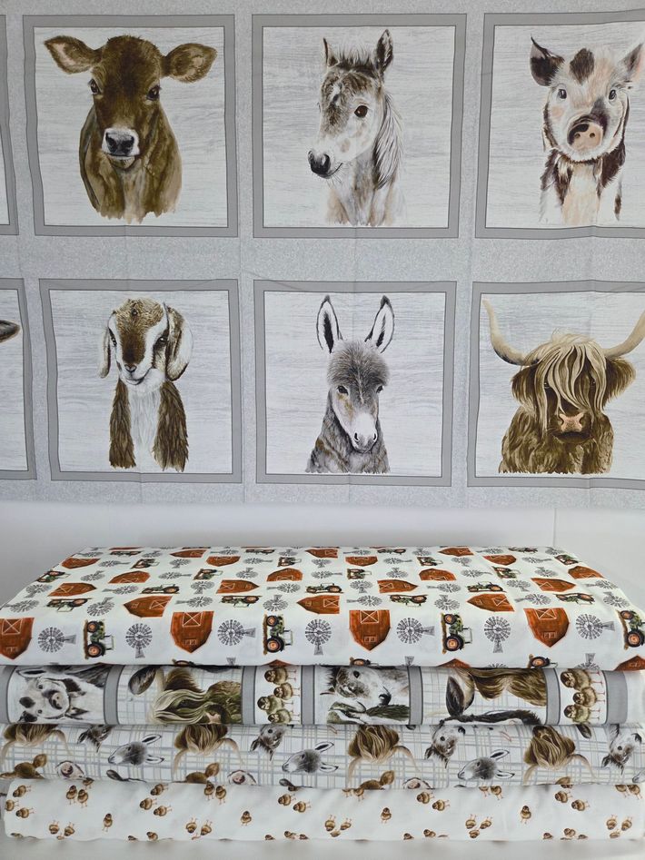 Wall with six framed animal portraits above a patterned bench with animal-print cushions and a furry throw