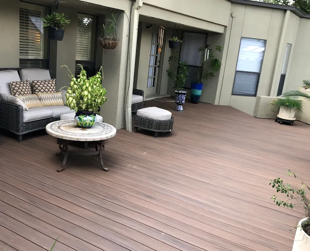 Modern brown composite deck with patio furniture.
