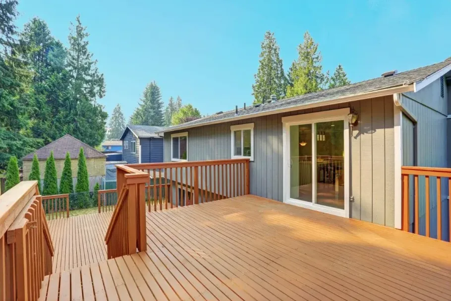 Modern wood deck on grey house.