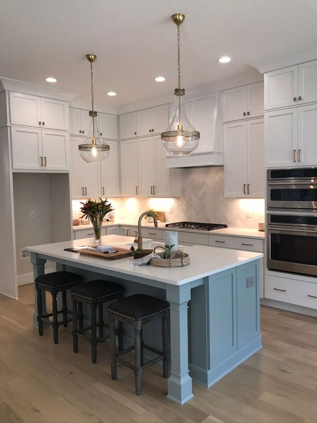 a kitchen with white cabinets and a large island - Raleigh, NC