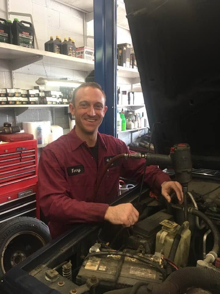 Auto Technician Working On Vehicle Engine | 4th Street Auto Care Center
