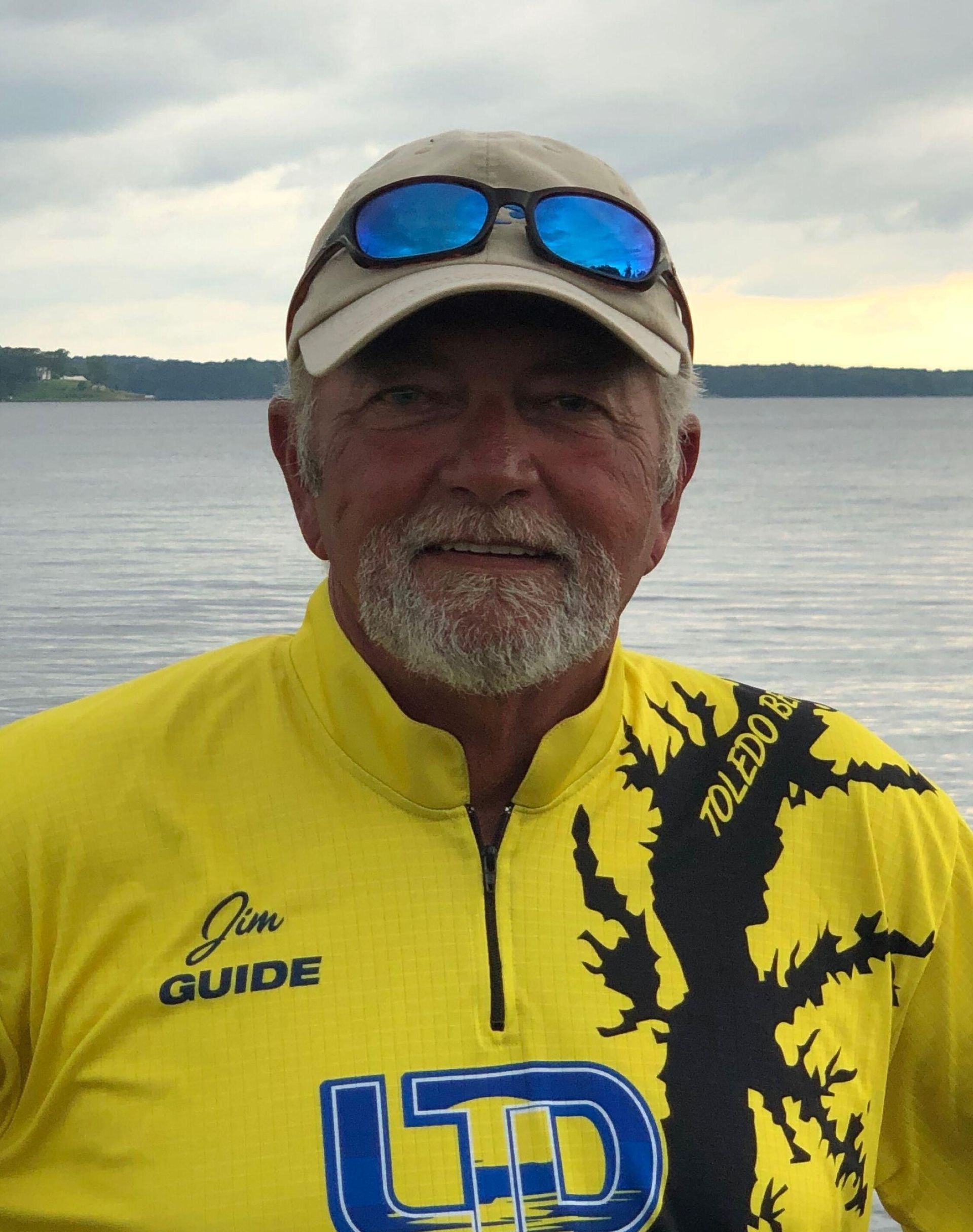 a man wearing a yellow shirt that says jon guide