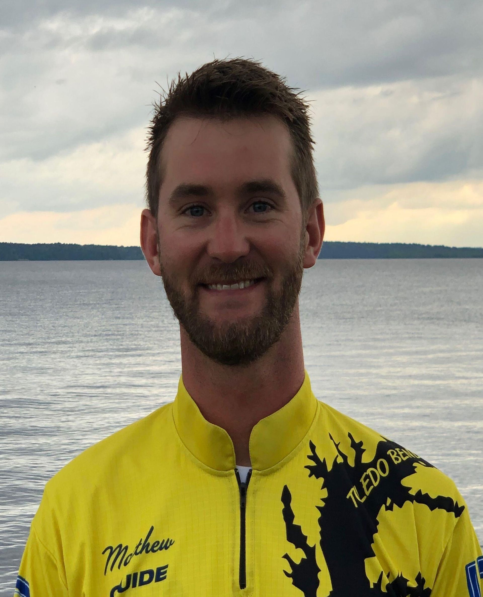a man wearing a yellow shirt that says michigan on it