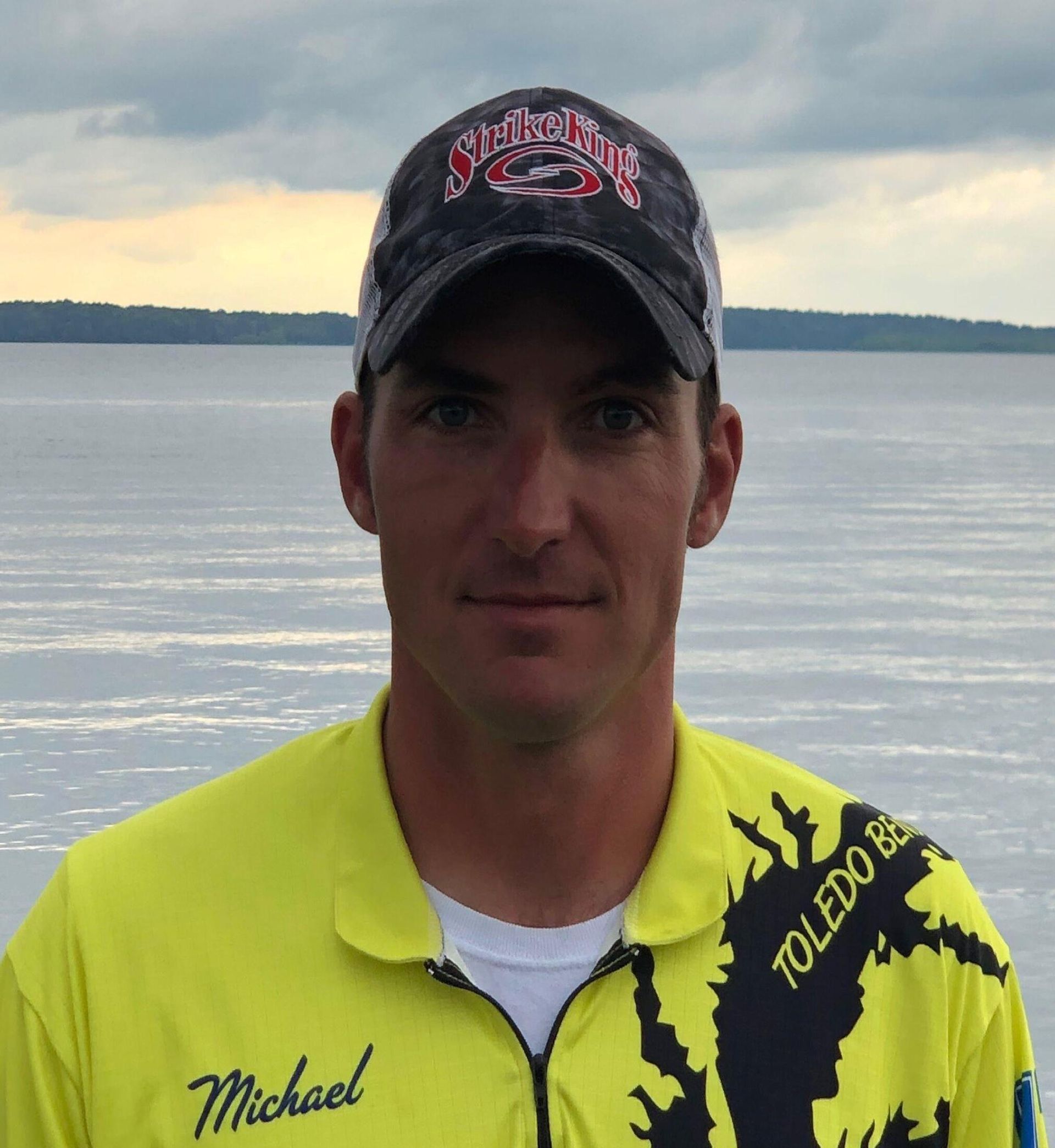 a man wearing a yellow shirt with toledo on it