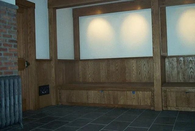 Empty wood-paneled room with frosted windows and a tiled floor