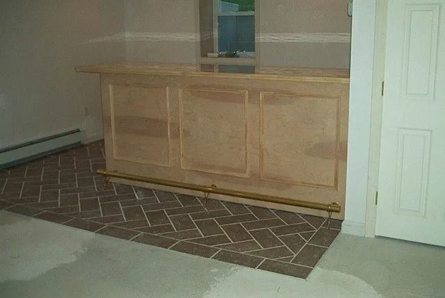 Wooden cabinet in front of a wall with a patterned rug on the floor