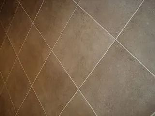 Brown textured tile floor with diagonal grout lines