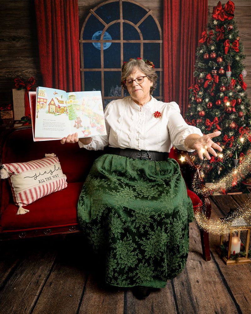 Mrs. Claus reads from a book with magical dust.