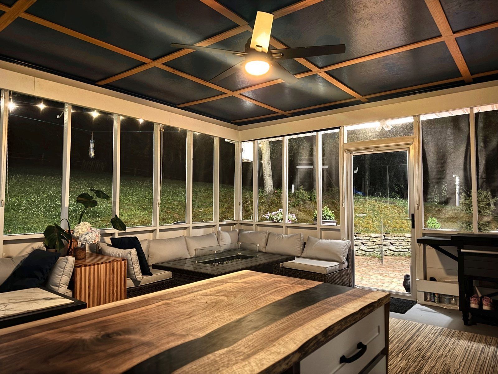 Screened porch with coffered ceiling and a live-edge walnut bar