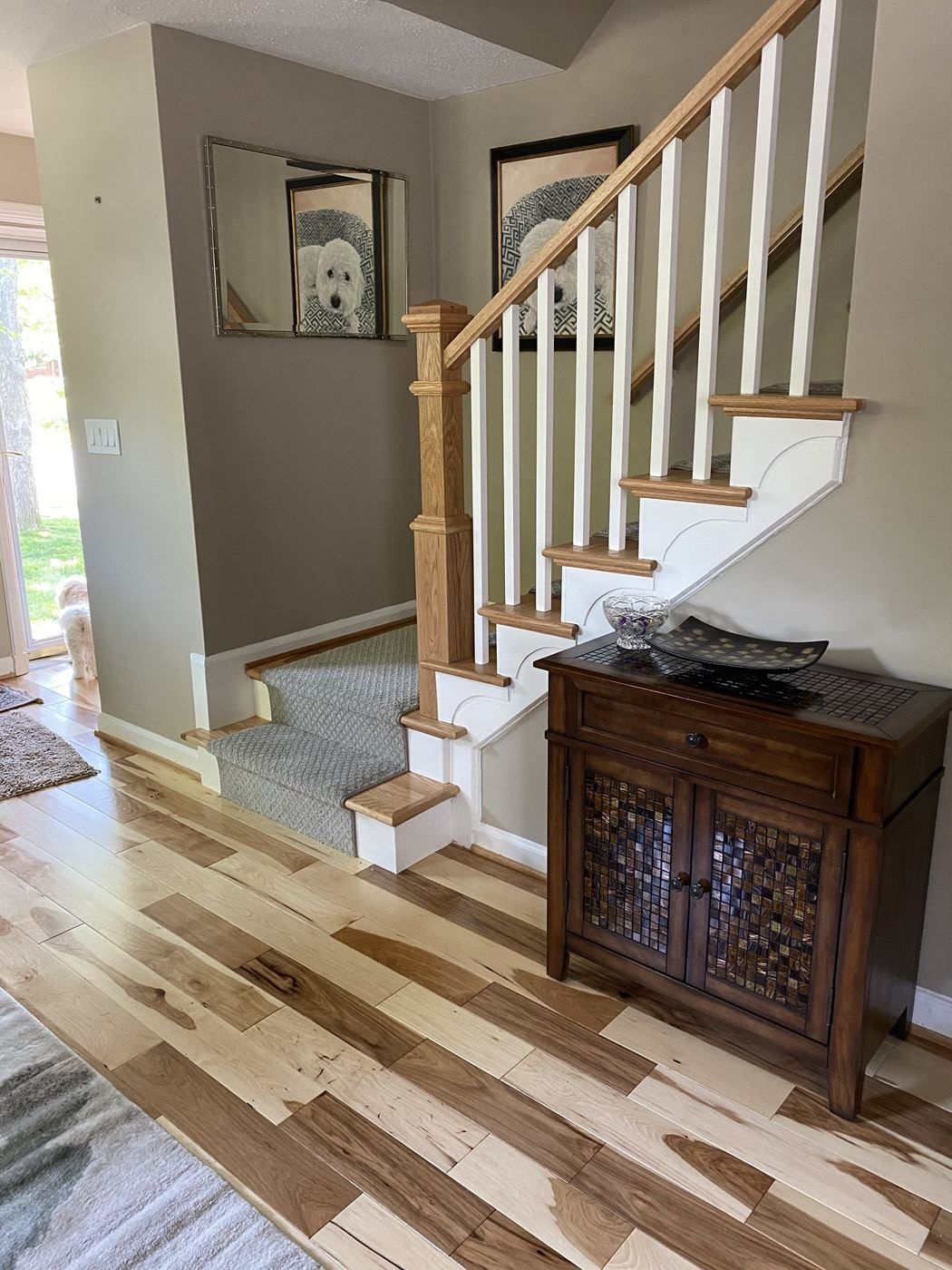 After: natural wood treads, box newel and white balusters with a stair runner over new hardwood floors