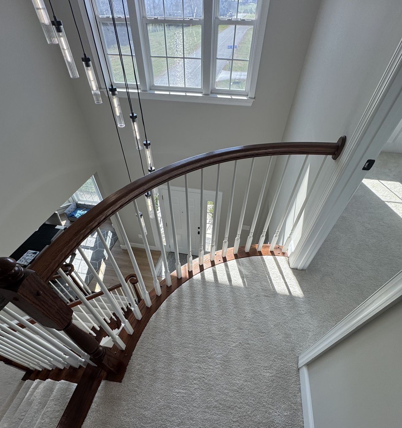 Before: curved balcony with dark oak rail and white spindles, seen from above