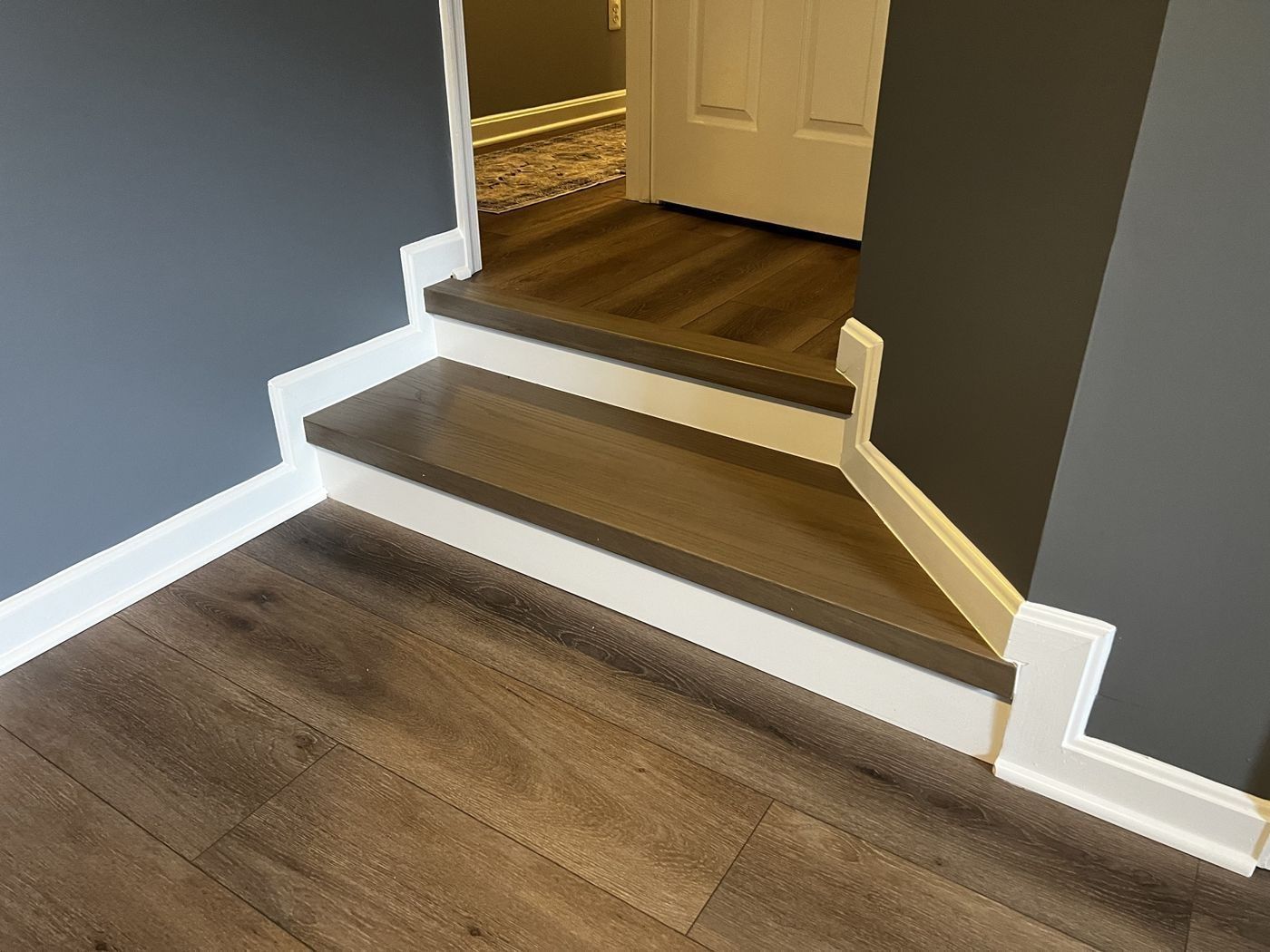 After: angled steps with new treads and white risers matched to the floor