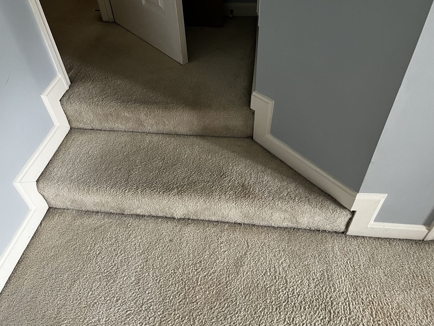Before: worn carpeted angled steps