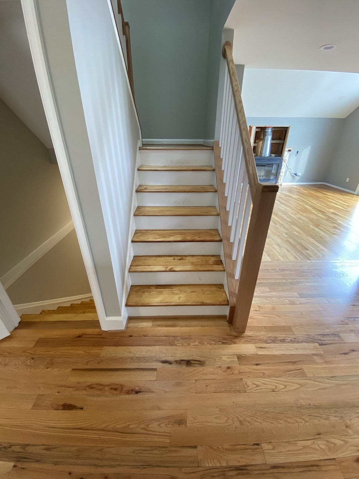 Before: painted white railing with worn oak treads