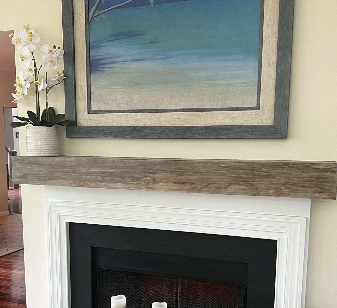 Gray-washed beam mantel over a white surround