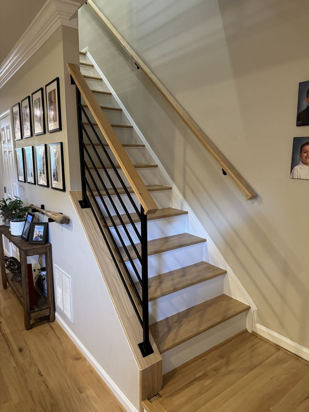 Modern horizontal black railing with oak handrail