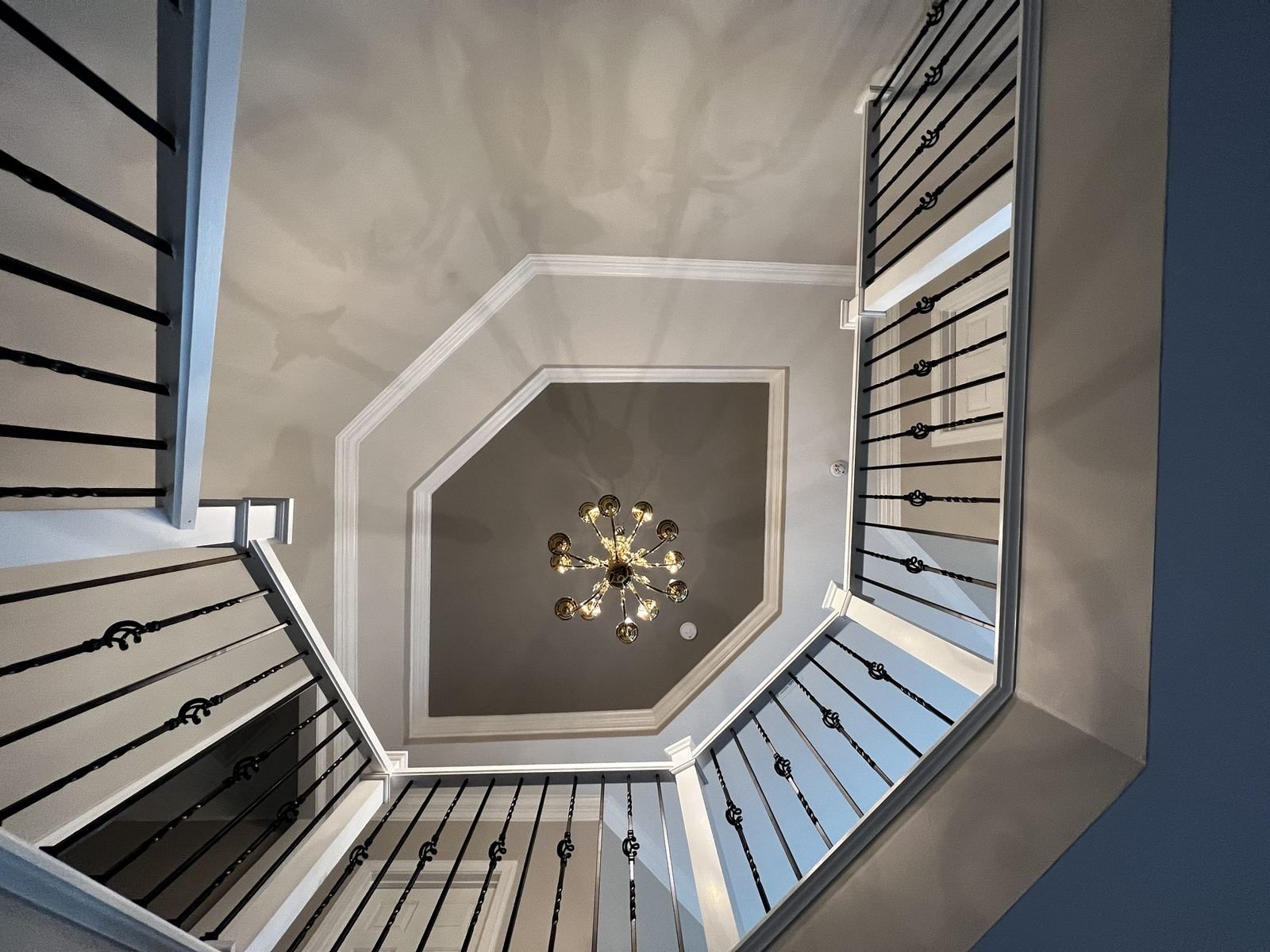 Looking up a three-story stairwell toward an octagonal ceiling