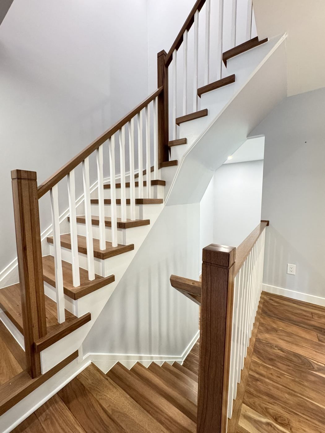 Walnut-toned stair with white balusters