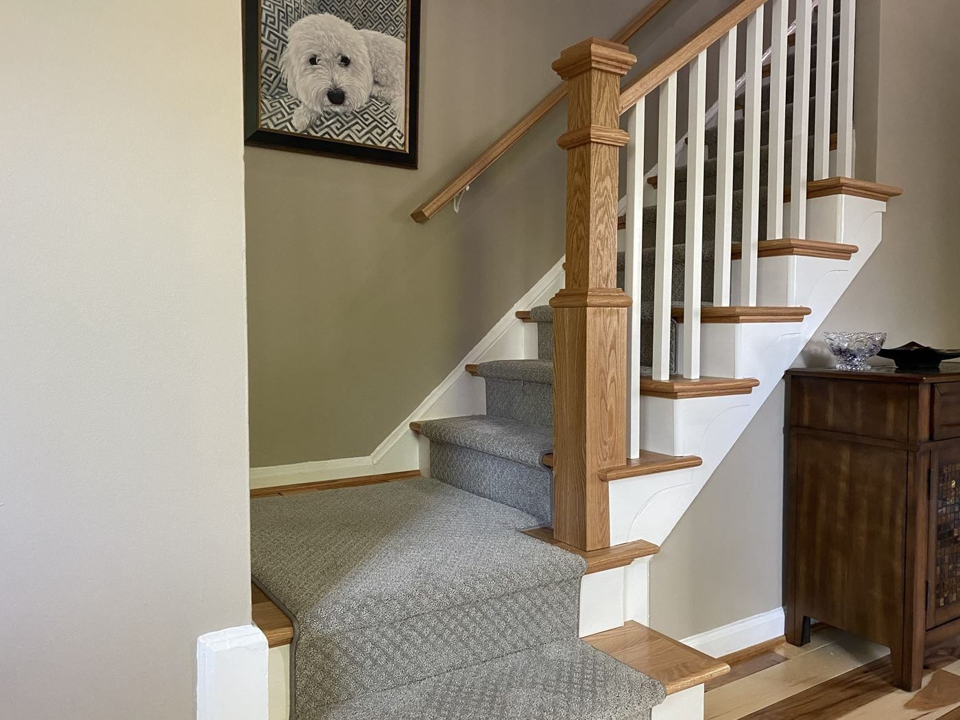 Oak newel stair with runner over hickory floors