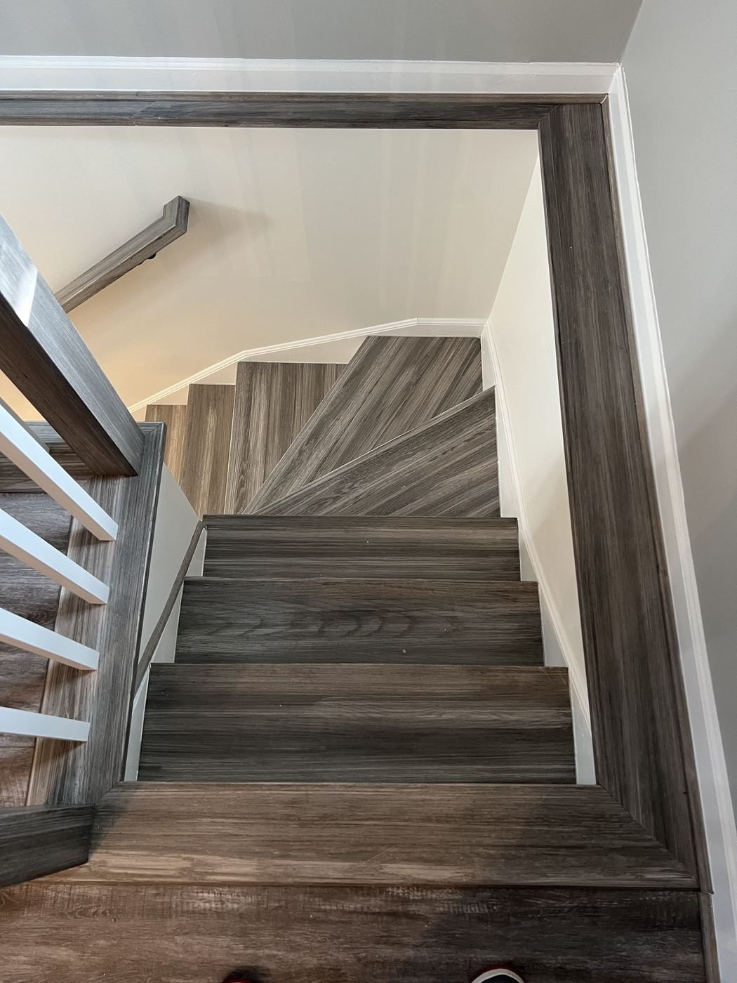 Gray plank winder stairs from above