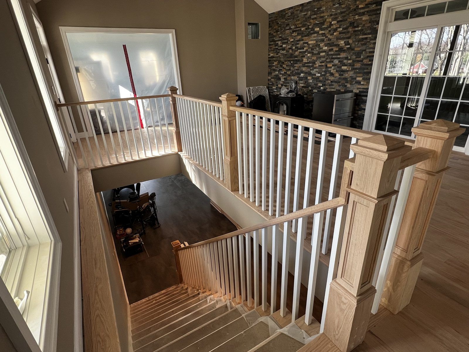 Two-story foyer stair with gray-stained newels