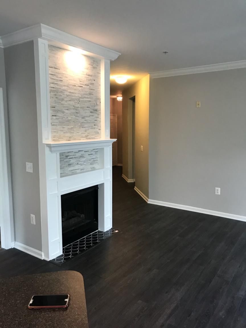 There is a fireplace in the middle of the living room.