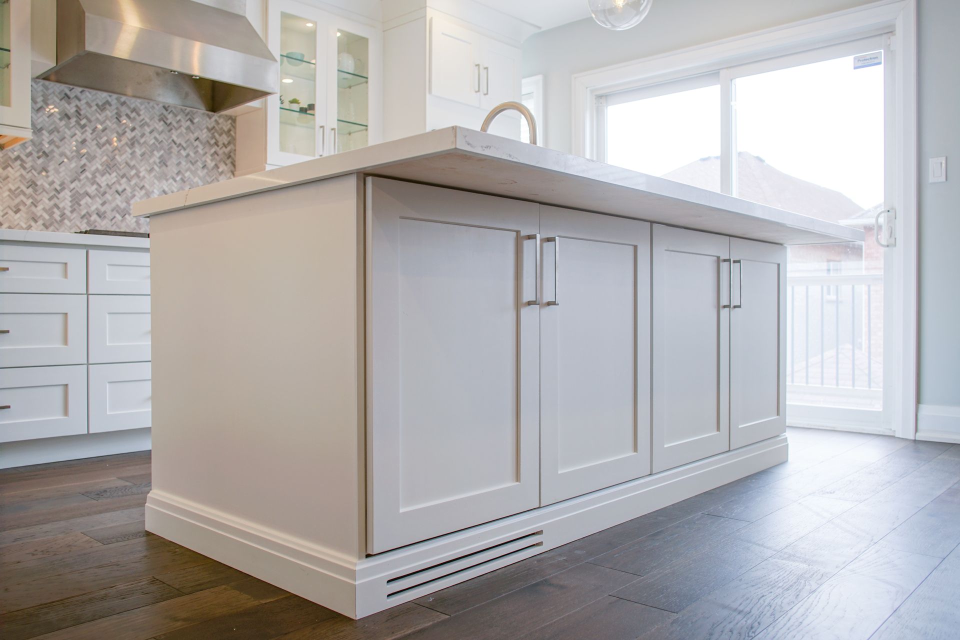 There is a large island in the middle of the kitchen.