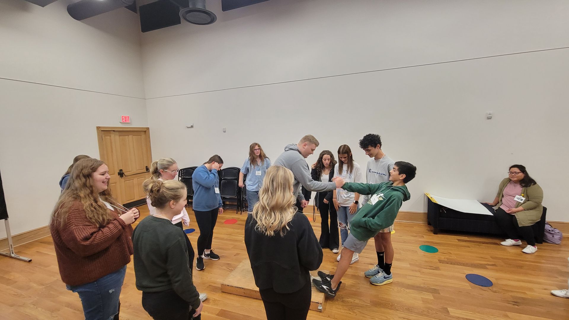 A group of people are standing in a room.