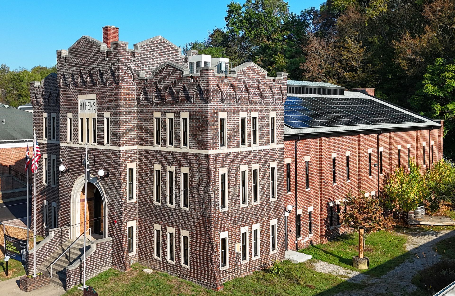 Athens Armory building flag visible. Sunny outdoor setting. Armory Park