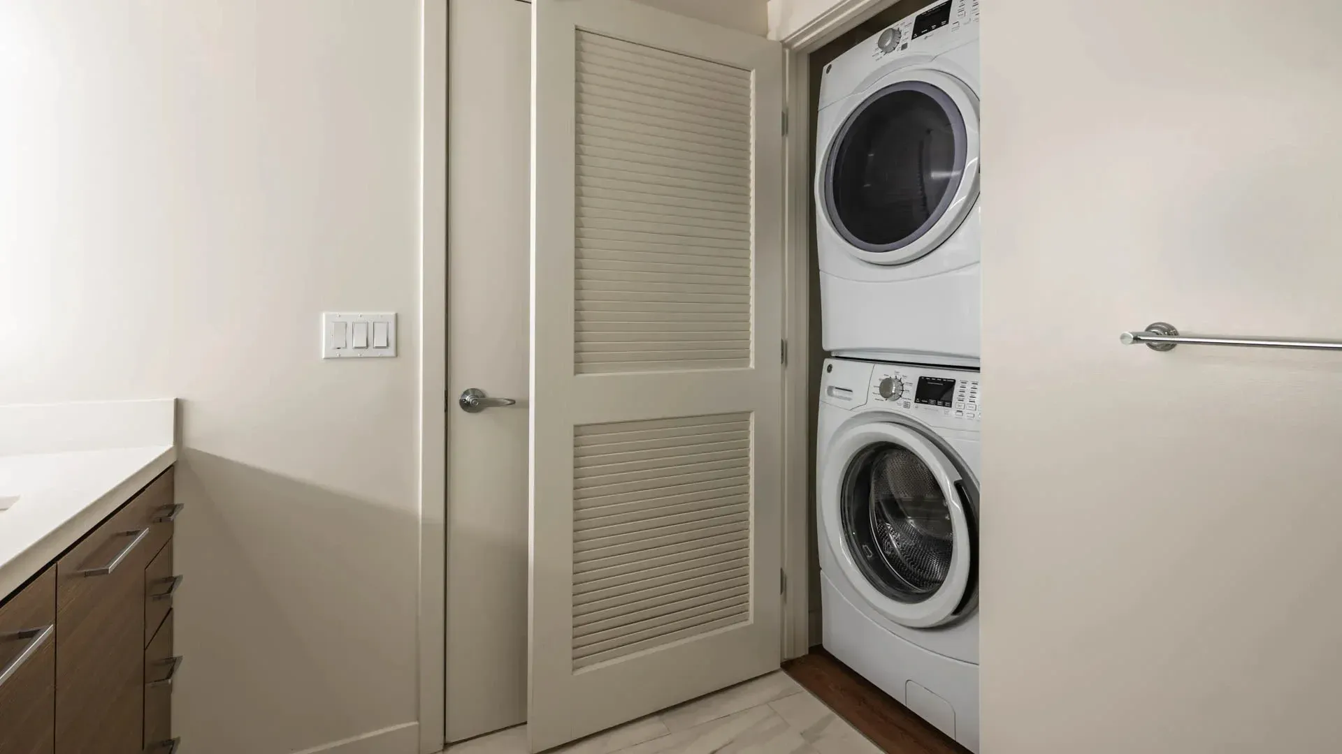 Stacked washer and dryer in a laundry closet.