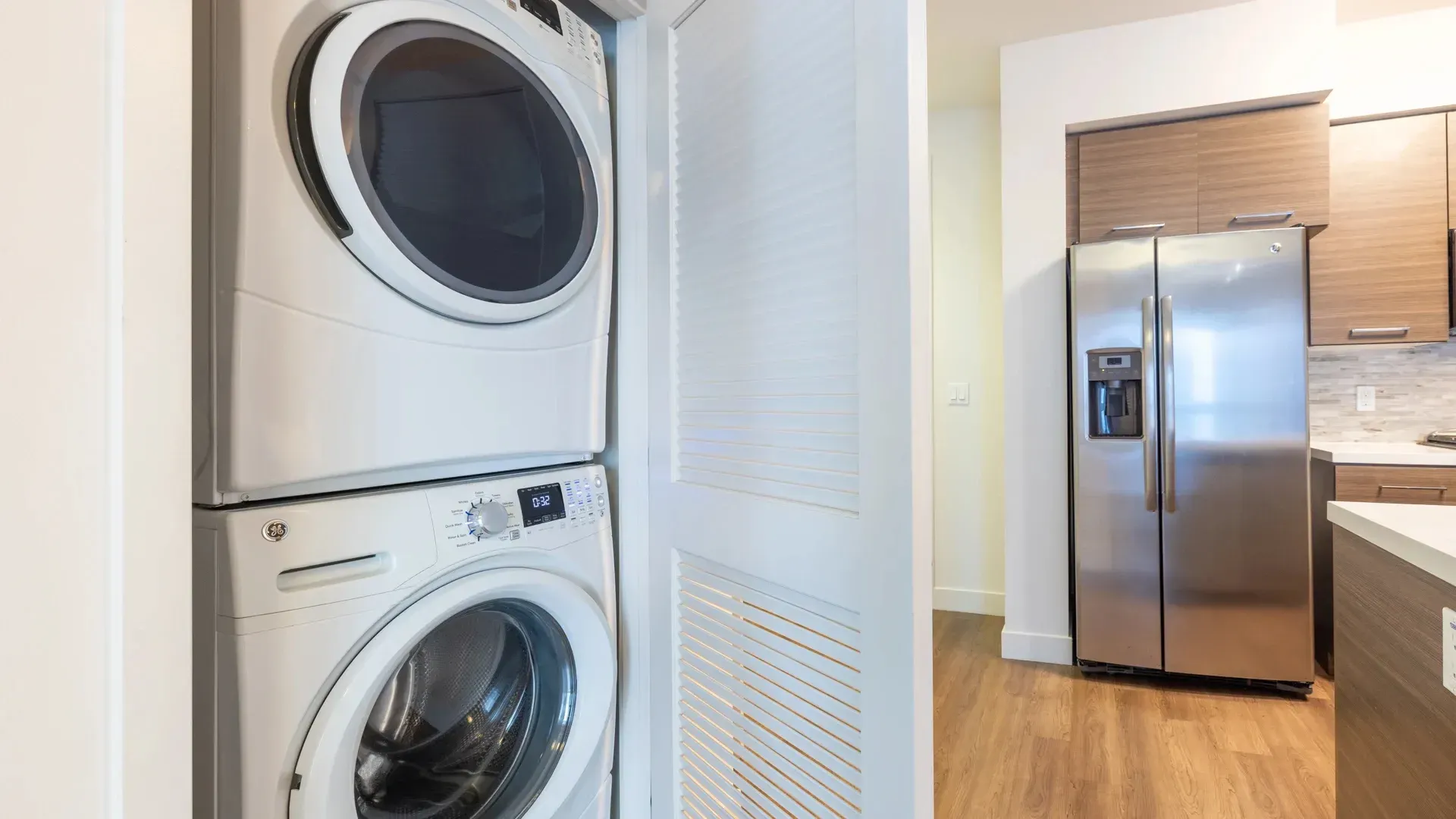 Stacked washer and dryer unit inside an apartment.