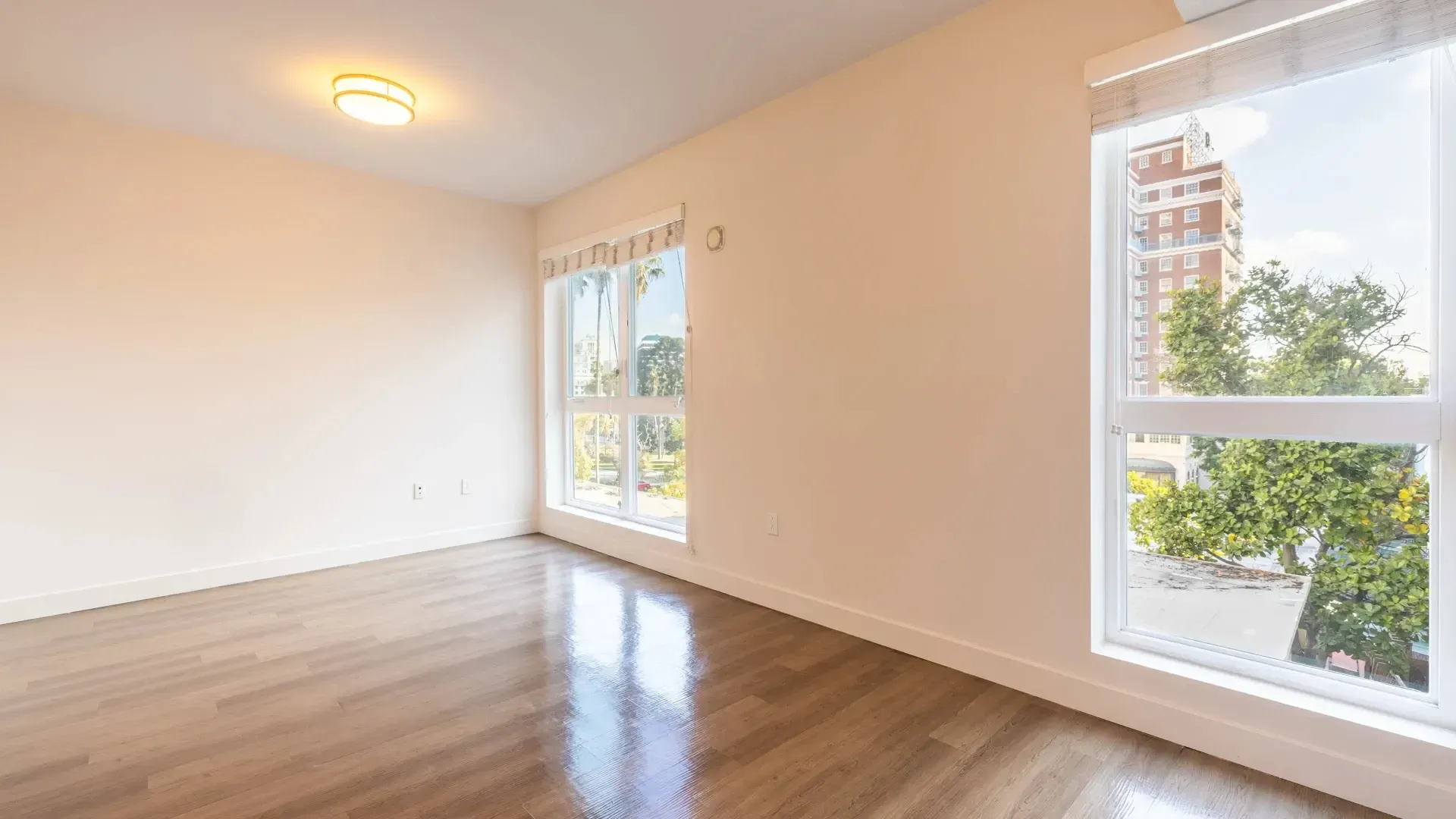 Empty room with large windows and city view