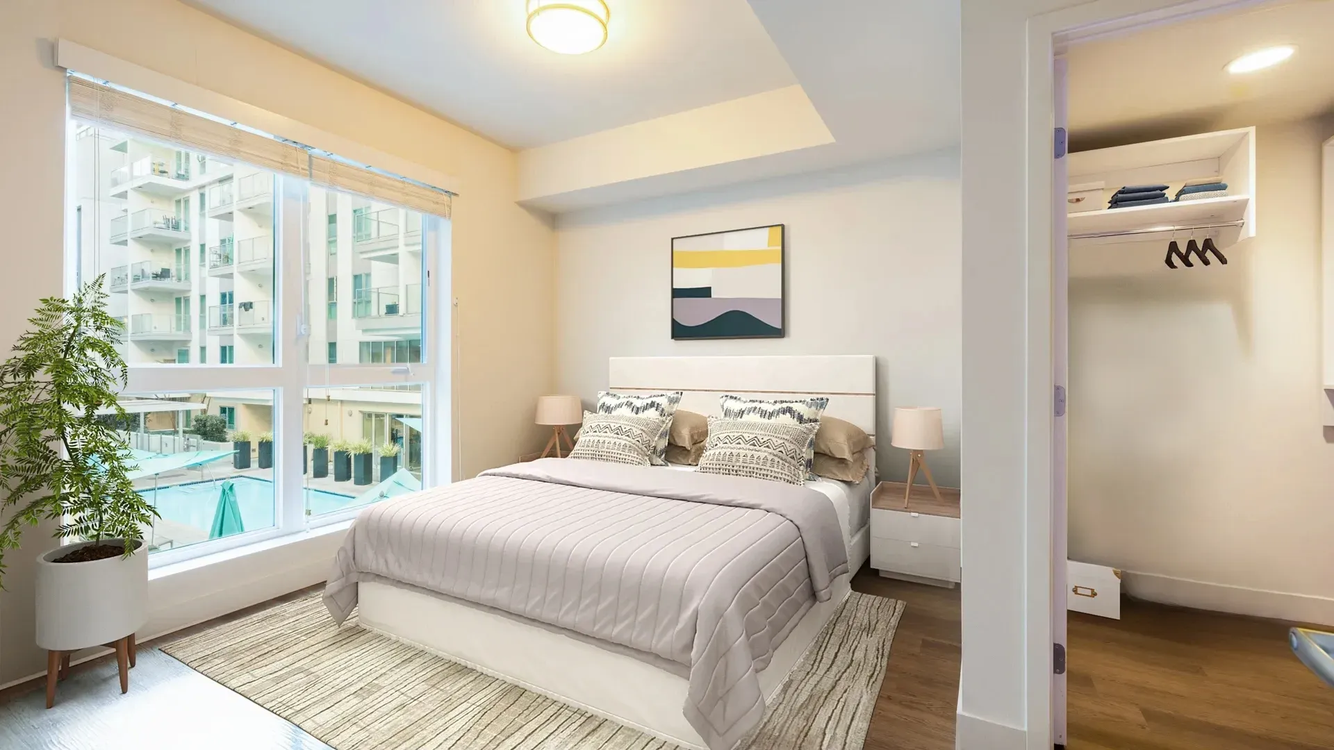 Bedroom with a large window overlooking a courtyard and pool