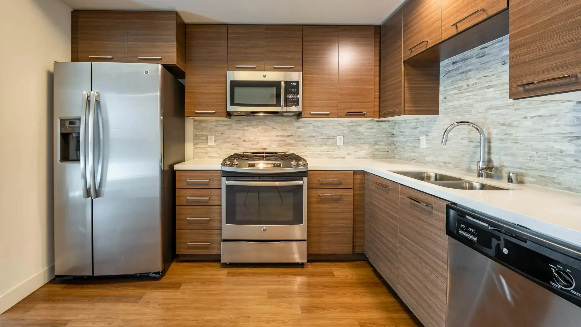 Modern kitchen with stainless steel appliances and wood cabinetry.