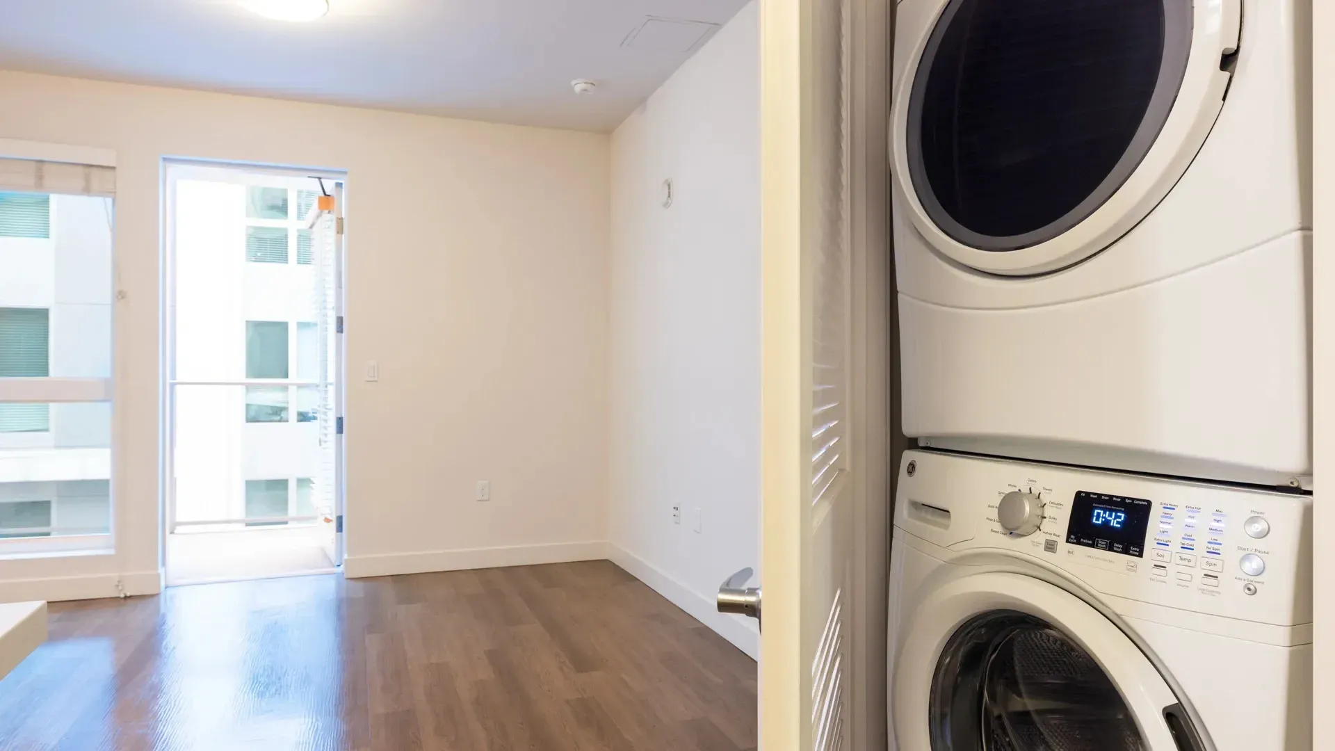Stackable washer and dryer in apartment laundry closet.