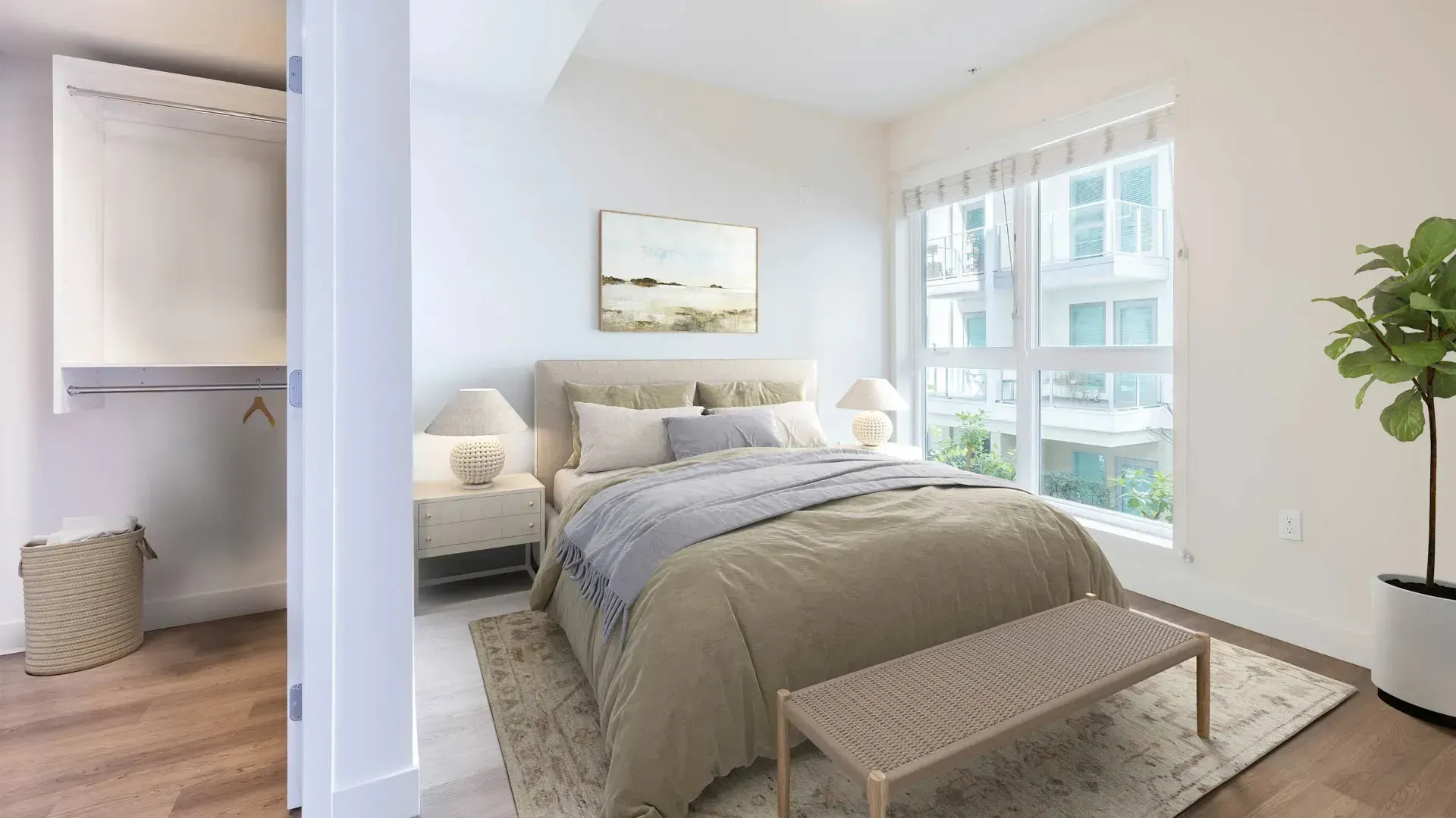 Bedroom with a queen-size bed, nightstands, a closet, and a large window.