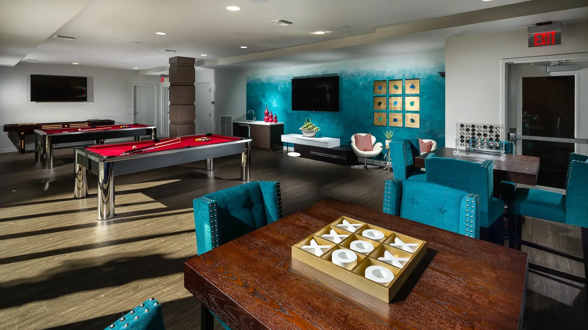 Community lounge with pool tables, seating areas, and games.