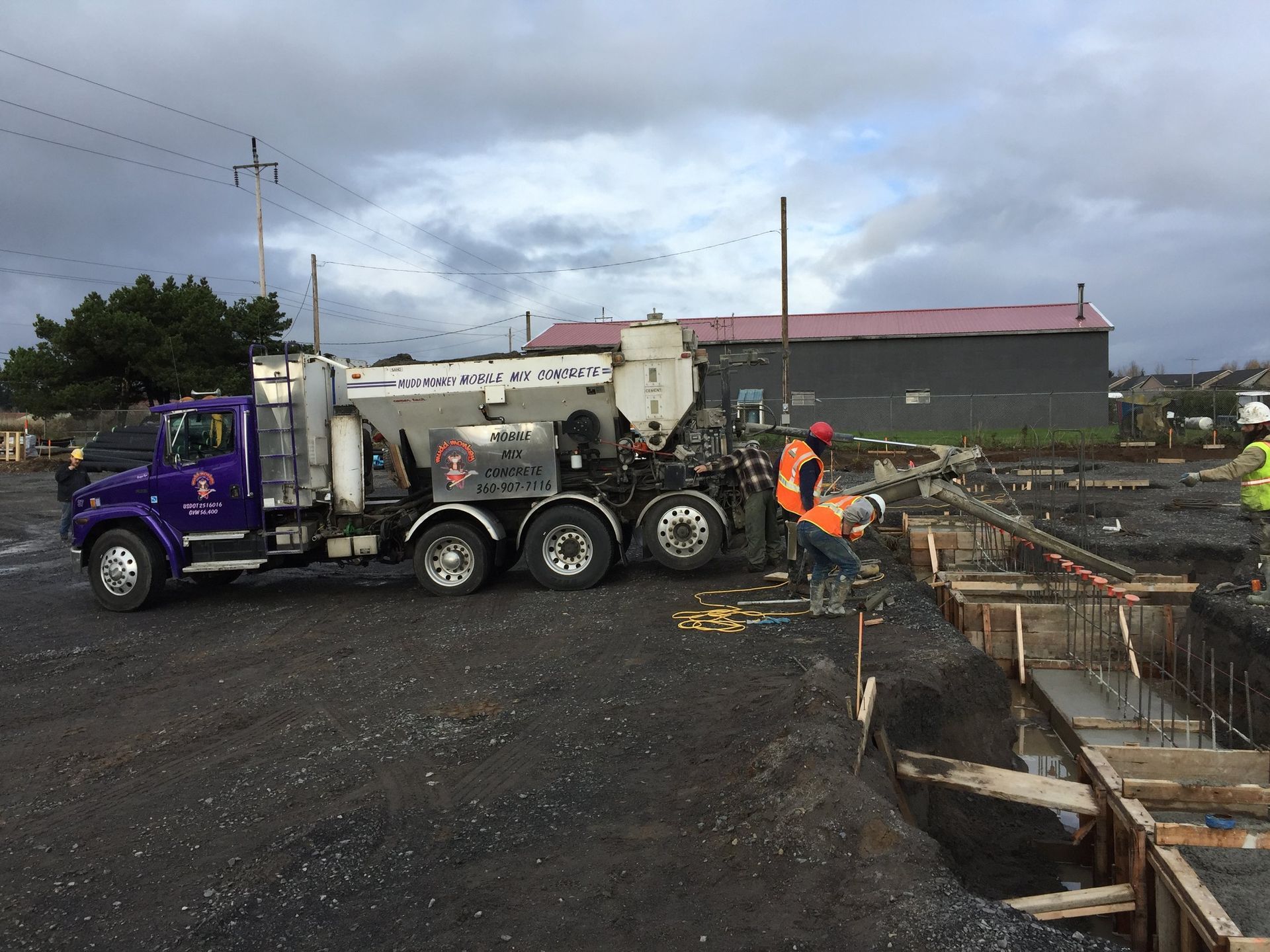 Concrete delivery near you in Vancouver, WA by Mudd Monkey Mobile Mix, delivering fresh on-site mixed concrete to another commercial concrete project. Trusted since 2014, Mudd Monkey provides precision volumetric concrete delivery for commercial, residential, and industrial jobs including driveways, patios, sidewalks, stamped concrete, and foundations. Schedule your concrete delivery today by calling 360-907-7116 or emailing muddmonkey2@gmail.com