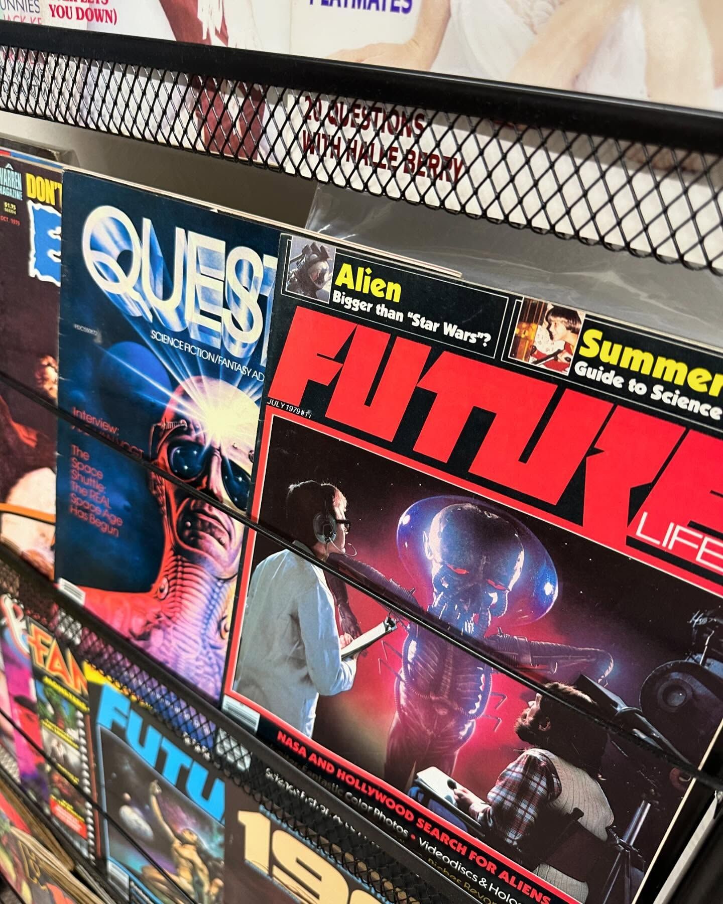 Magazine rack with colorful sci-fi magazines, including Quest and Future Life covers