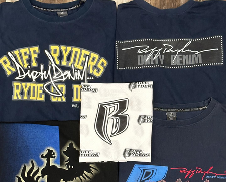 Assorted graphic T-shirts with bold logos in navy, black, white, and blue, laid out together