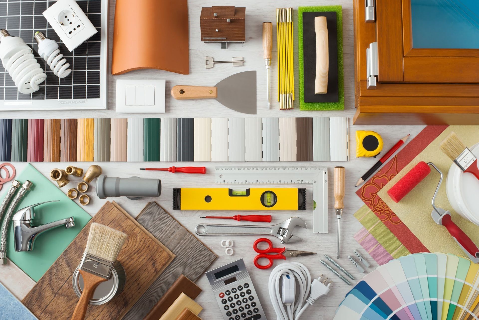 DIY home improvement tools and paint swatches arranged on a worktable