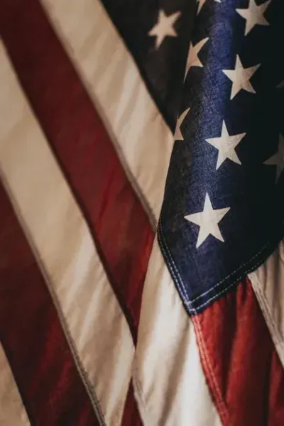 Close-up of a folded American flag with red, white, and blue stripes and white stars