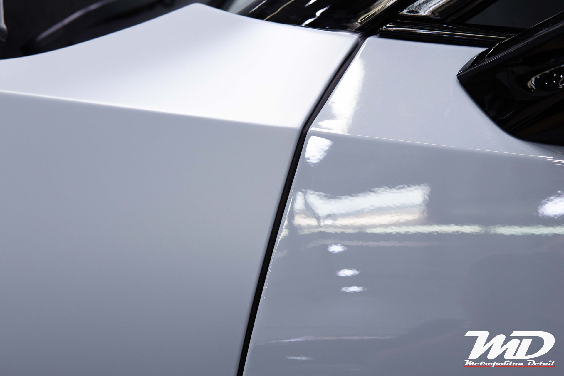 A close up of a white car with a wd logo on the side