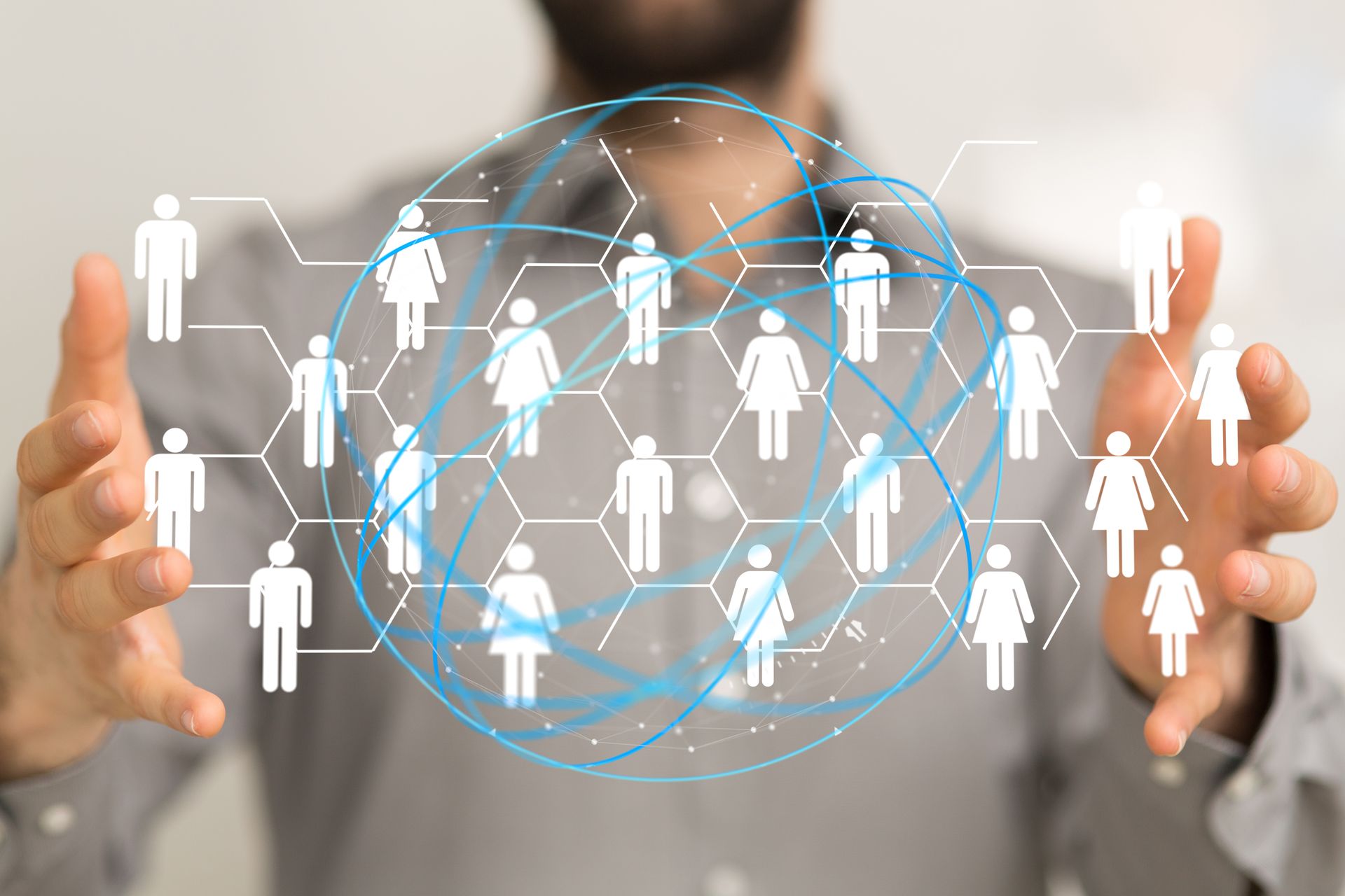 A man is holding a circle of people in his hands.