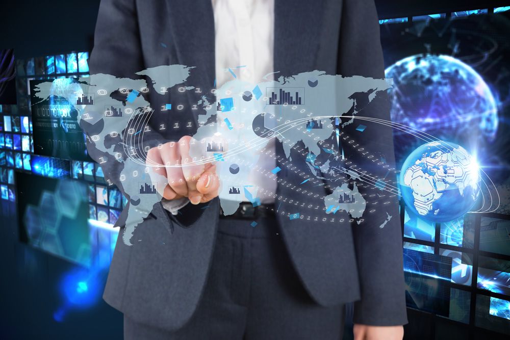 A man in a suit is pointing at a map of the world