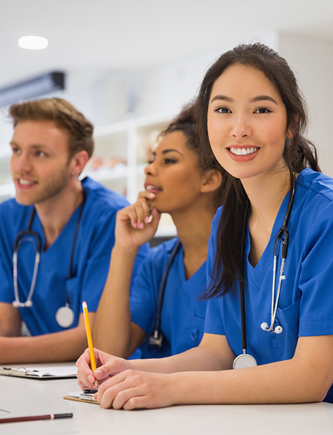a group of nurses at Willow Grove CPR are sitting at a table and smiling .