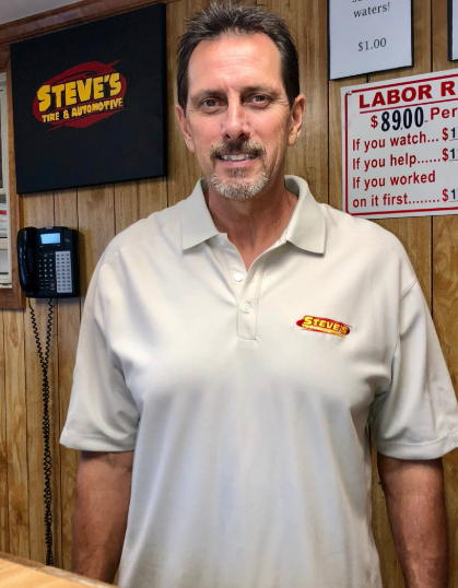 A man standing in front of a steve 's sign